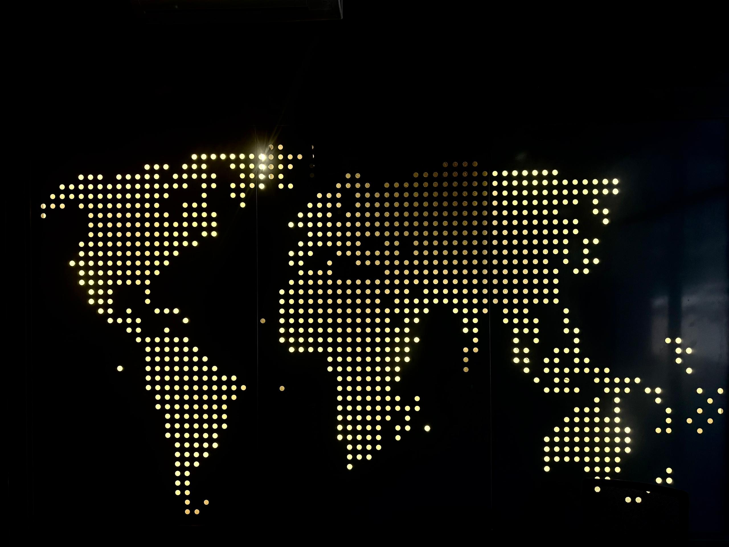Back-lit perforated world-map panel